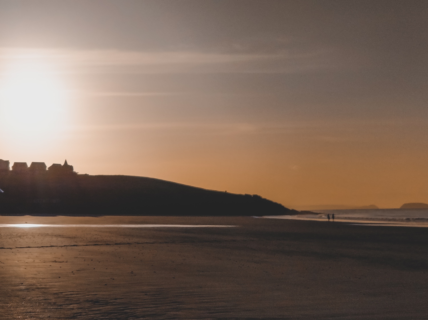 The sun rising over the headland