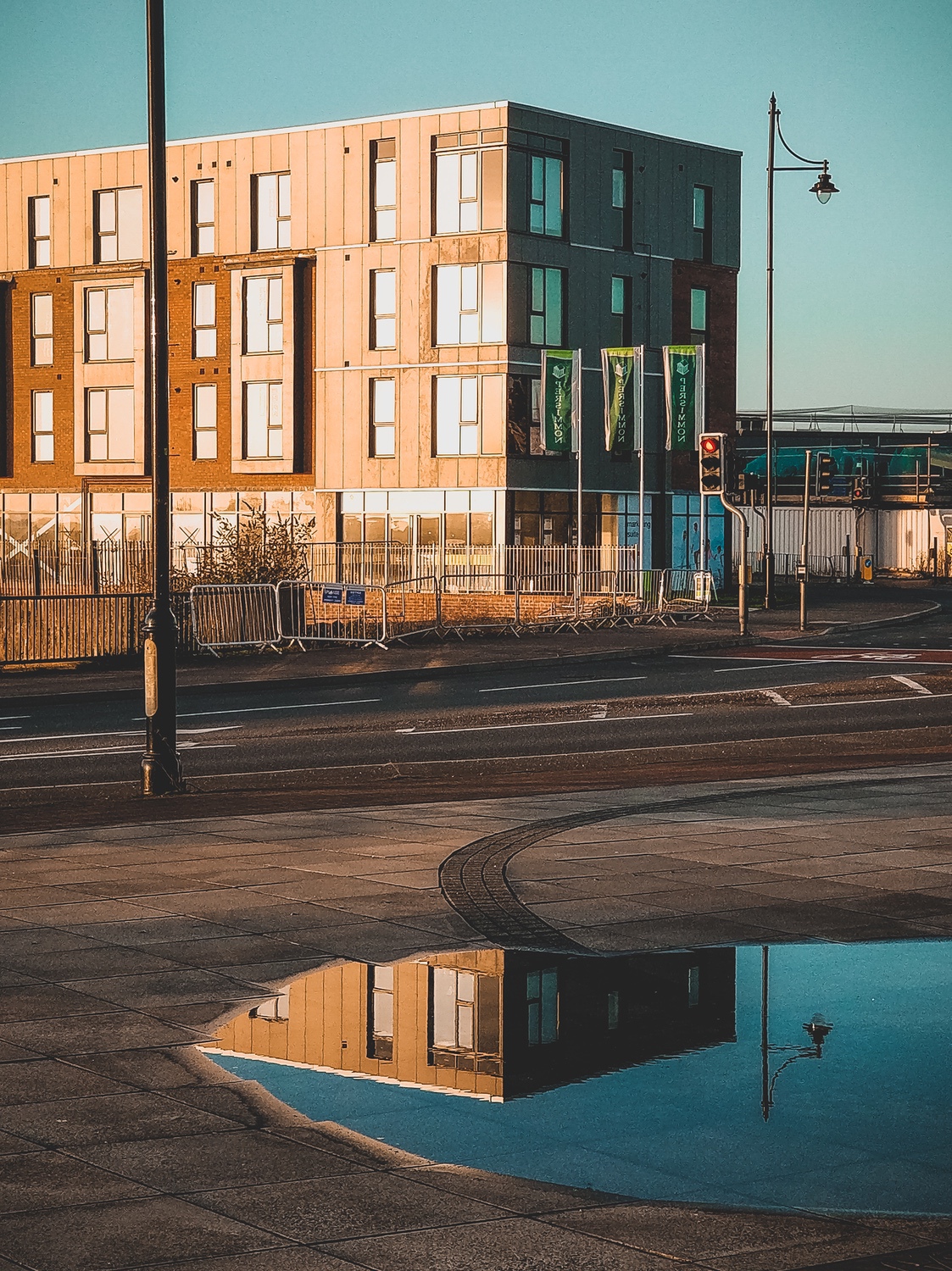 Reflections of the new houses in the puddles