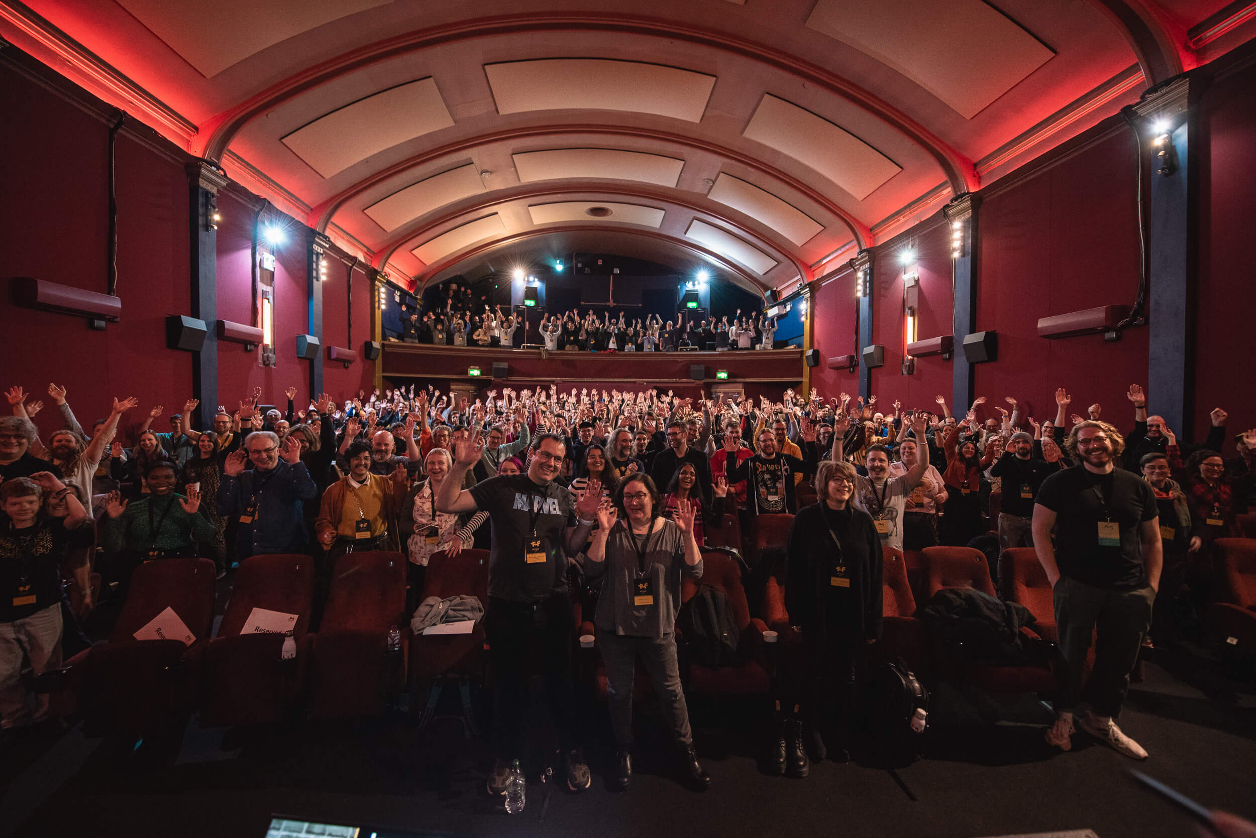 The now iconic FFConf 2023 photo from the stage, looking out at all the attendees with their hands in the air