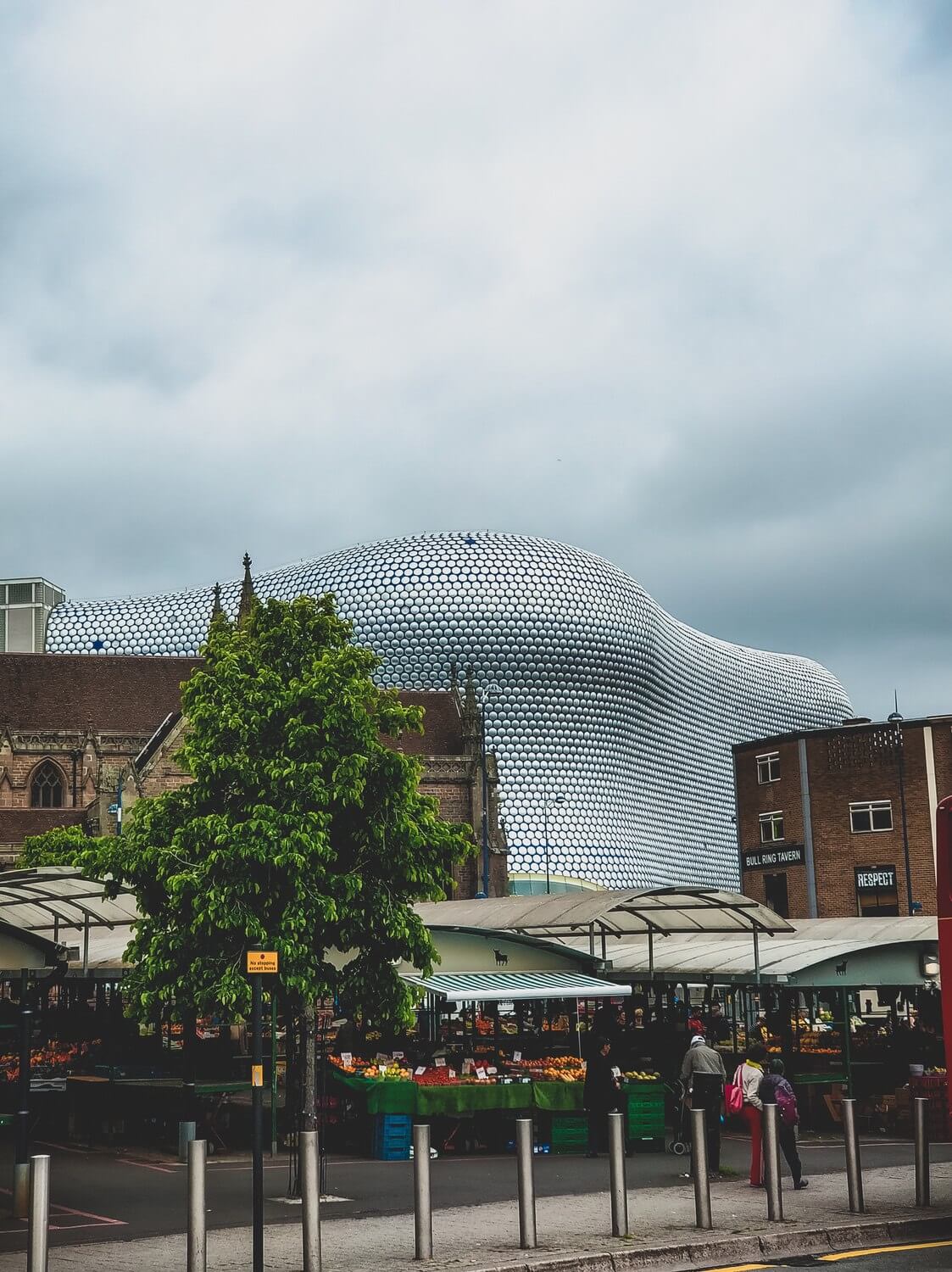 Looking through a market to the bullring building.